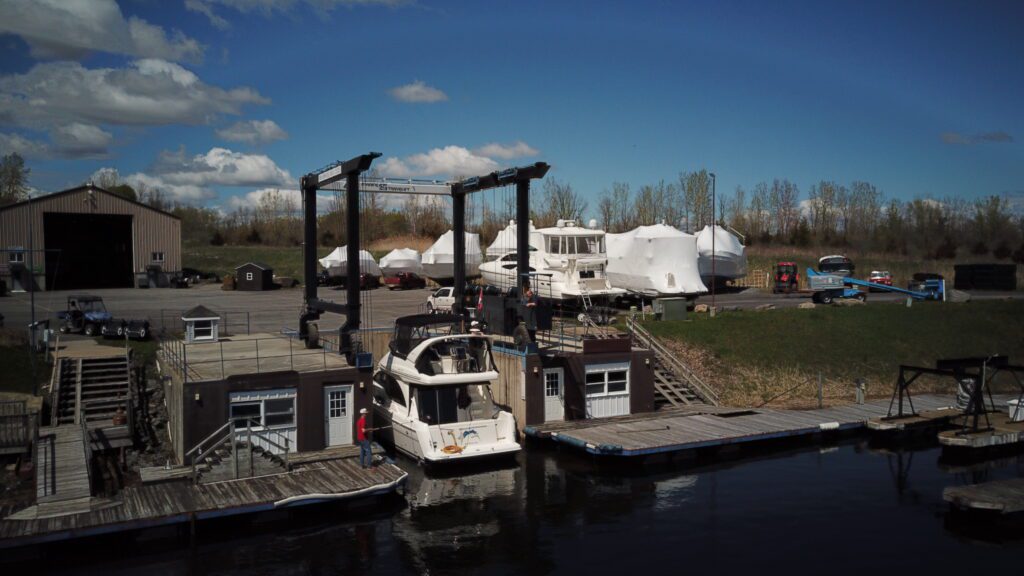 A boat dock with several boats parked in the water.